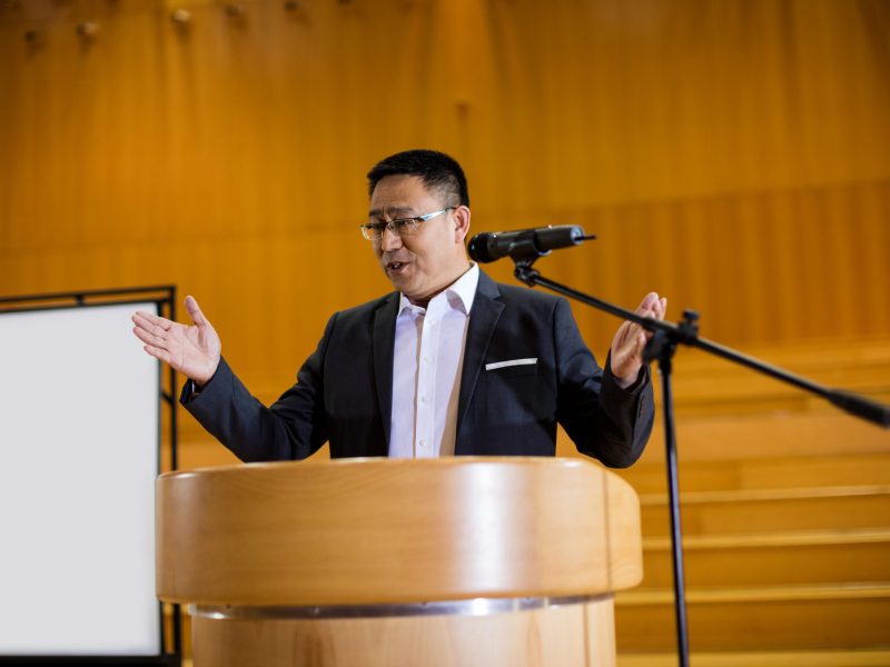 Male business executive giving a speech at conference center