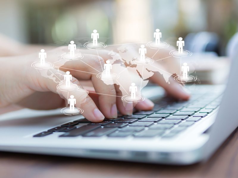 Closeup of business woman hand typing on laptop keyboard